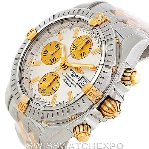 This image shows a Breitling Chronomat B13356 Men's Steel and Gold (two tone) Silver Dial B13356 Men's Steel and Gold (two tone) Silver Dial model watch featuring a detailed view from an angle prominently displaying the dial, crown, and pushers.