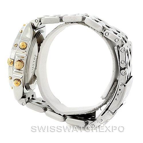 The image shows a side view of the Breitling Chronomat B13352 Men
s Steel and Gold (two tone) Black Dial B13352 Men
s Steel and Gold (two tone) Black Dial watch, focusing on the watch case, crown, pushers, and part of the metal bracelet.