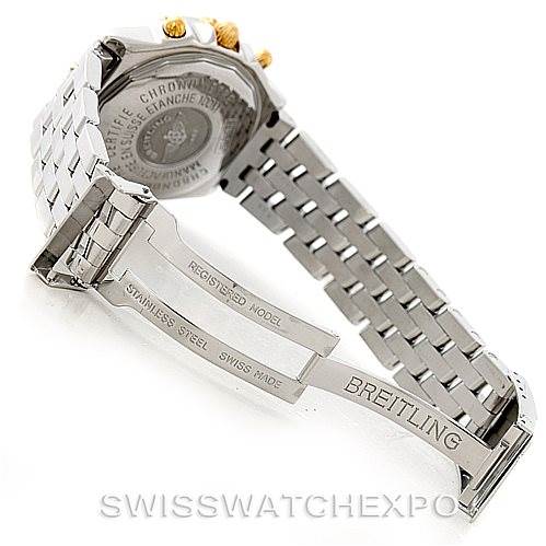 The image shows the open stainless steel bracelet and clasp of a Breitling Chronomat B13352 Men
s Steel and Gold (two tone) Black Dial B13352 Men
s Steel and Gold (two tone) Black Dial watch, with the case back partially visible.