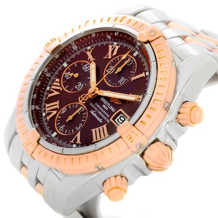 The image shows a close-up side view of a Breitling Chronomat C13356 Men's Steel and Gold (two tone) Burgundy Dial C13356 Men's Steel and Gold (two tone) Burgundy Dial watch, highlighting its bezel, crown, pushers, and dial.