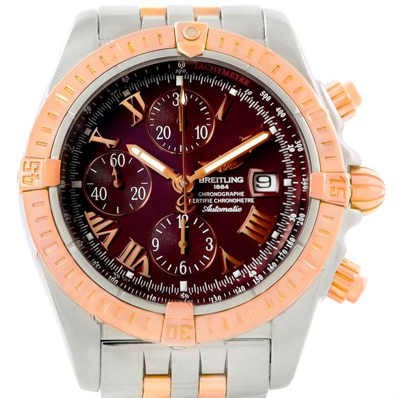 The image shows a Breitling Chronomat watch from a front angle, highlighting the dial, bezel, and chronograph sub-dials.