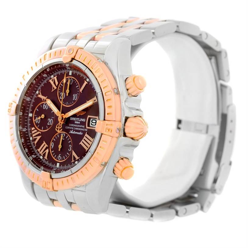 This image shows a side-angle view of a Breitling Chronomat C13356 Men's Steel and Gold (two tone) Burgundy Dial C13356 Men's Steel and Gold (two tone) Burgundy Dial watch, highlighting the face, bezel, crown, and part of the bracelet.