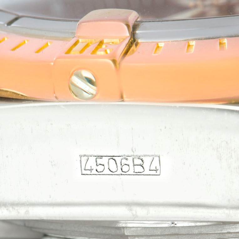 Close-up of the Breitling Chronomat C13356 Men's Steel and Gold (two tone) Burgundy Dial C13356 Men's Steel and Gold (two tone) Burgundy Dial watch showing part of the bezel, screw, and engraving on the case back.