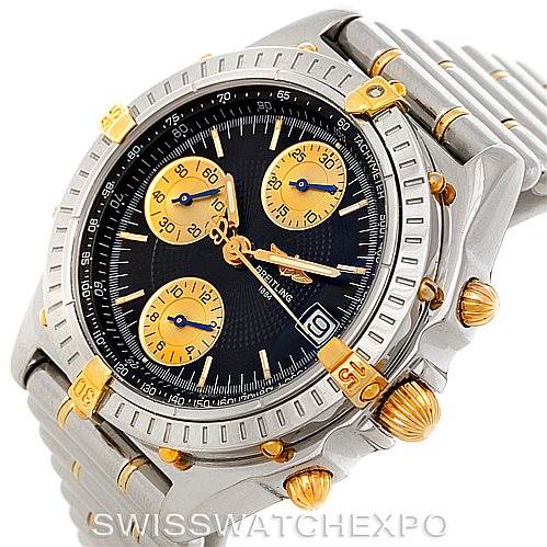 The image shows a Breitling Chronomat B13050 Men's Steel and Gold (two tone) Black Dial B13050 Men's Steel and Gold (two tone) Black Dial watch from a three-quarter angle, highlighting the face, bezel, and bracelet.