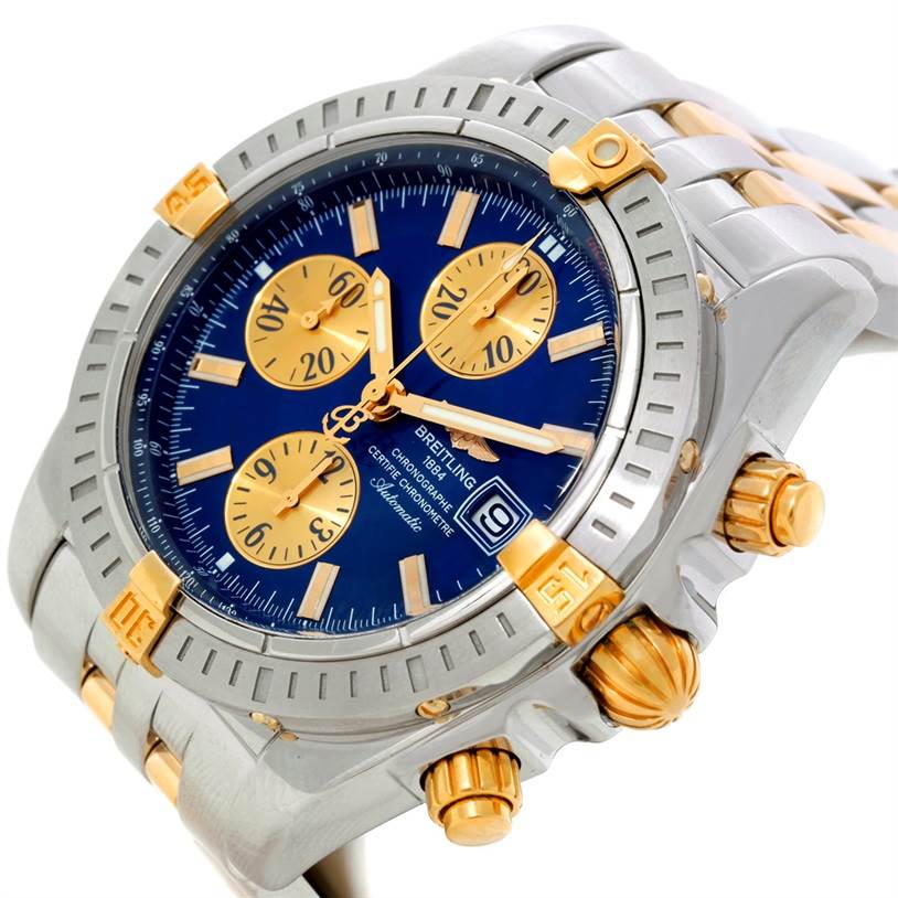 The image shows a close-up angled view of a Breitling Chronomat B13356 Men's Steel and Gold (two tone) Blue Dial B13356 Men's Steel and Gold (two tone) Blue Dial watch, highlighting its face, bezel, and chronograph pushers.