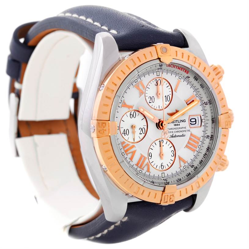 The Breitling Chronomat C13356 Men
s Steel and Gold (two tone) White Dial C13356 Men
s Steel and Gold (two tone) White Dial watch is shown from an angled side view, highlighting the face, bezel, straps, and chronograph dials.