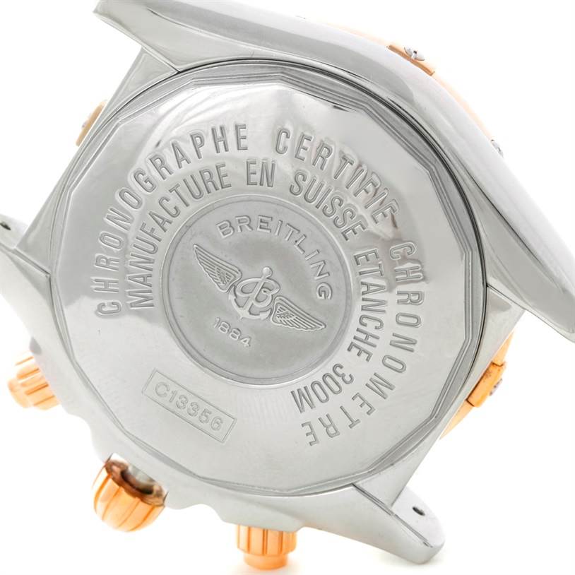 The image shows the case back of a Breitling Chronomat C13356 Men
s Steel and Gold (two tone) White Dial C13356 Men
s Steel and Gold (two tone) White Dial watch, highlighting its engraved branding and certification details.
