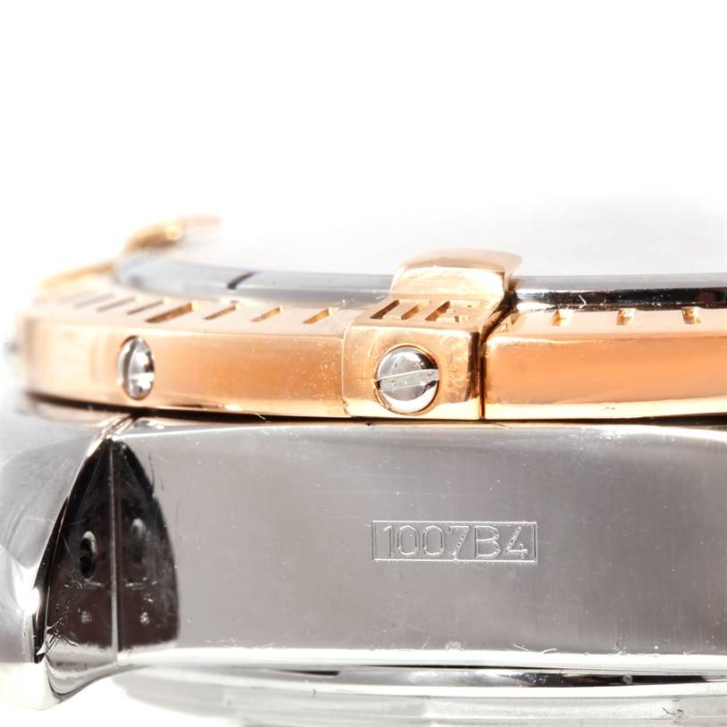 This image shows a close-up of the bezel and case side of the Breitling Chronomat C13356 Men
s Steel and Gold (two tone) White Dial C13356 Men
s Steel and Gold (two tone) White Dial watch, with visible serial number and screws.