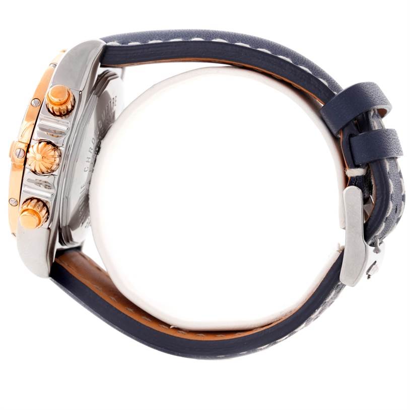 The image shows a side view of the Breitling Chronomat C13356 Men
s Steel and Gold (two tone) White Dial C13356 Men
s Steel and Gold (two tone) White Dial watch, highlighting the crown, pushers, and strap.