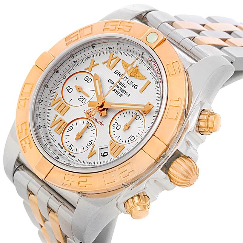 The image shows a Breitling Chronomat CB0140 Men's Steel and Gold (two tone) White Dial CB0140 Men's Steel and Gold (two tone) White Dial watch from a tilted angle, highlighting the dial, bezel, crown, and part of the bracelet.