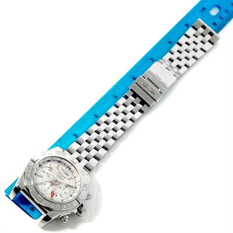 The Breitling Chronomat AB0410 Men's Stainless Steel Silver Dial AB0410 Men's Stainless Steel Silver Dial watch is shown lying flat, displaying the face, bezel, bracelet, and clasp.