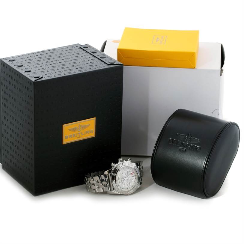 The image shows a Breitling Chronomat AB0410 Men's Stainless Steel Silver Dial AB0410 Men's Stainless Steel Silver Dial watch with its packaging, including a black box, a leather case, and a yellow box.