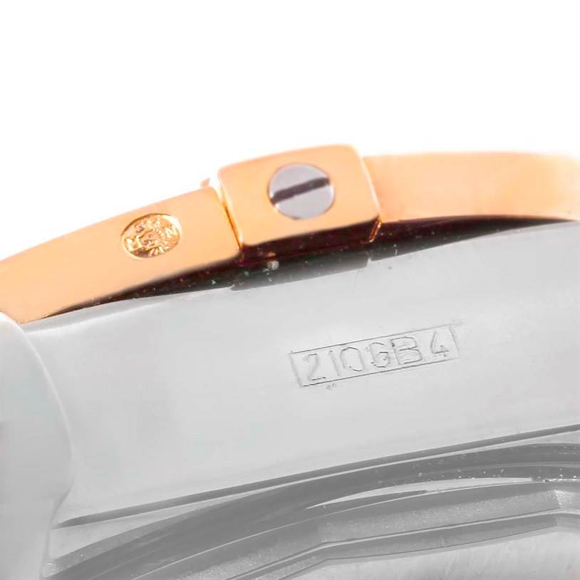 This close-up image shows part of the clasp and the serial number on the band of a Breitling Chronomat C13356 Men's Steel and Gold (two tone) White Dial C13356 Men's Steel and Gold (two tone) White Dial watch.