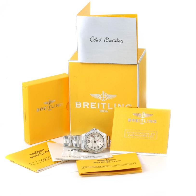The Breitling Colt A32350 Men's Stainless Steel Beige Dial A32350 Men's Stainless Steel Beige Dial watch is displayed with its box and accompanying booklets and documentation.