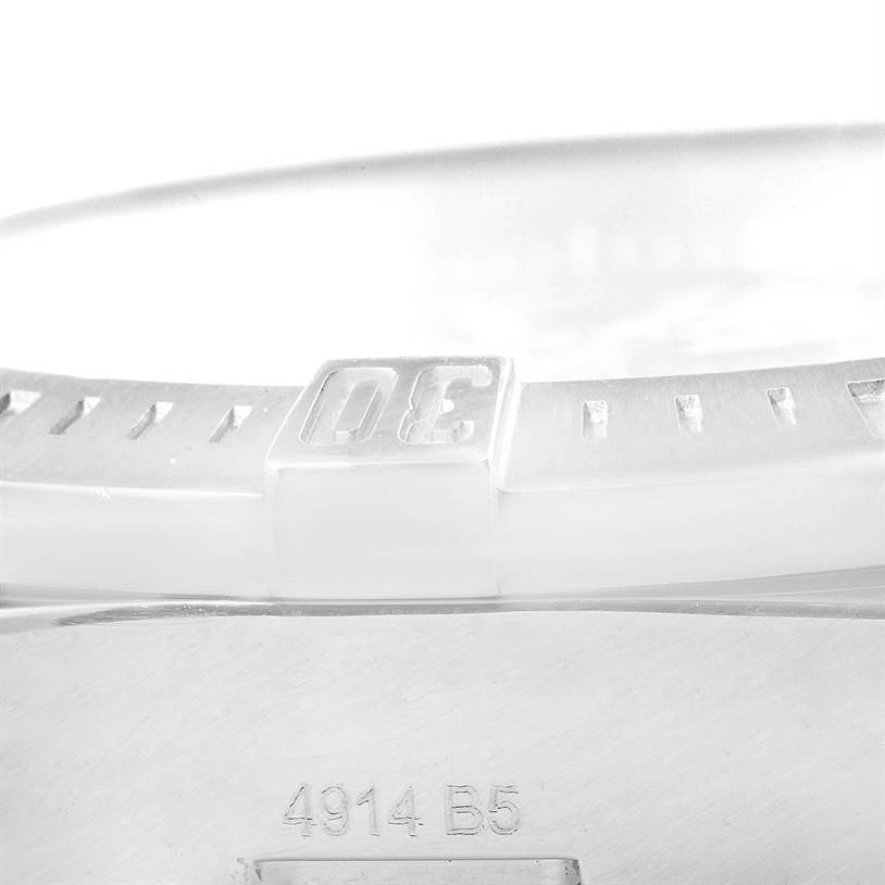The image shows a close-up of the bezel and a portion of the case back of a Breitling Colt A74388 Men
s Stainless Steel Blue Dial A74388 Men
s Stainless Steel Blue Dial watch.