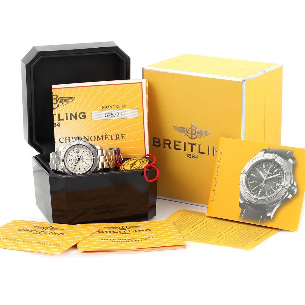 The Breitling Colt A17380 Men's Stainless Steel Silver Dial A17380 Men's Stainless Steel Silver Dial watch is shown inside its open black case alongside manuals, a tag, and the original yellow Breitling box. 