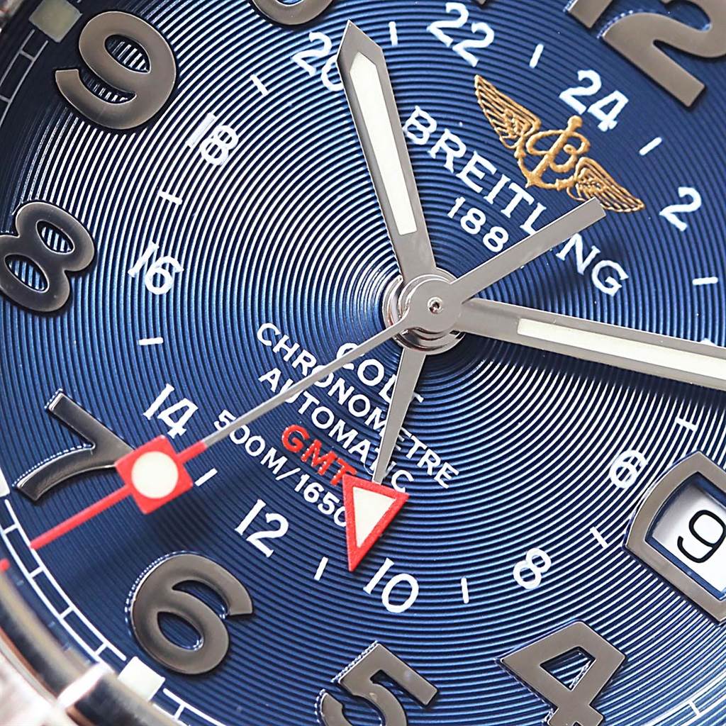 The image shows a close-up of the Breitling Colt A32350 Men's Stainless Steel Blue Dial A32350 Men's Stainless Steel Blue Dial watch dial, featuring the hands, brand logo, and GMT indicator.
