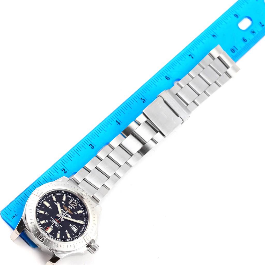 This image shows a top-down view of a Breitling Colt A17388 Men's Stainless Steel Black Dial A17388 Men's Stainless Steel Black Dial watch with its stainless steel bracelet and a ruler for reference.