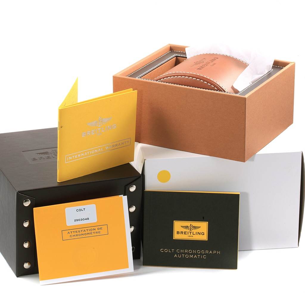 This image shows the packaging, warranty booklets, and watch case for a Breitling Colt A13388 Men's Stainless Steel Blue Dial A13388 Men's Stainless Steel Blue Dial model.