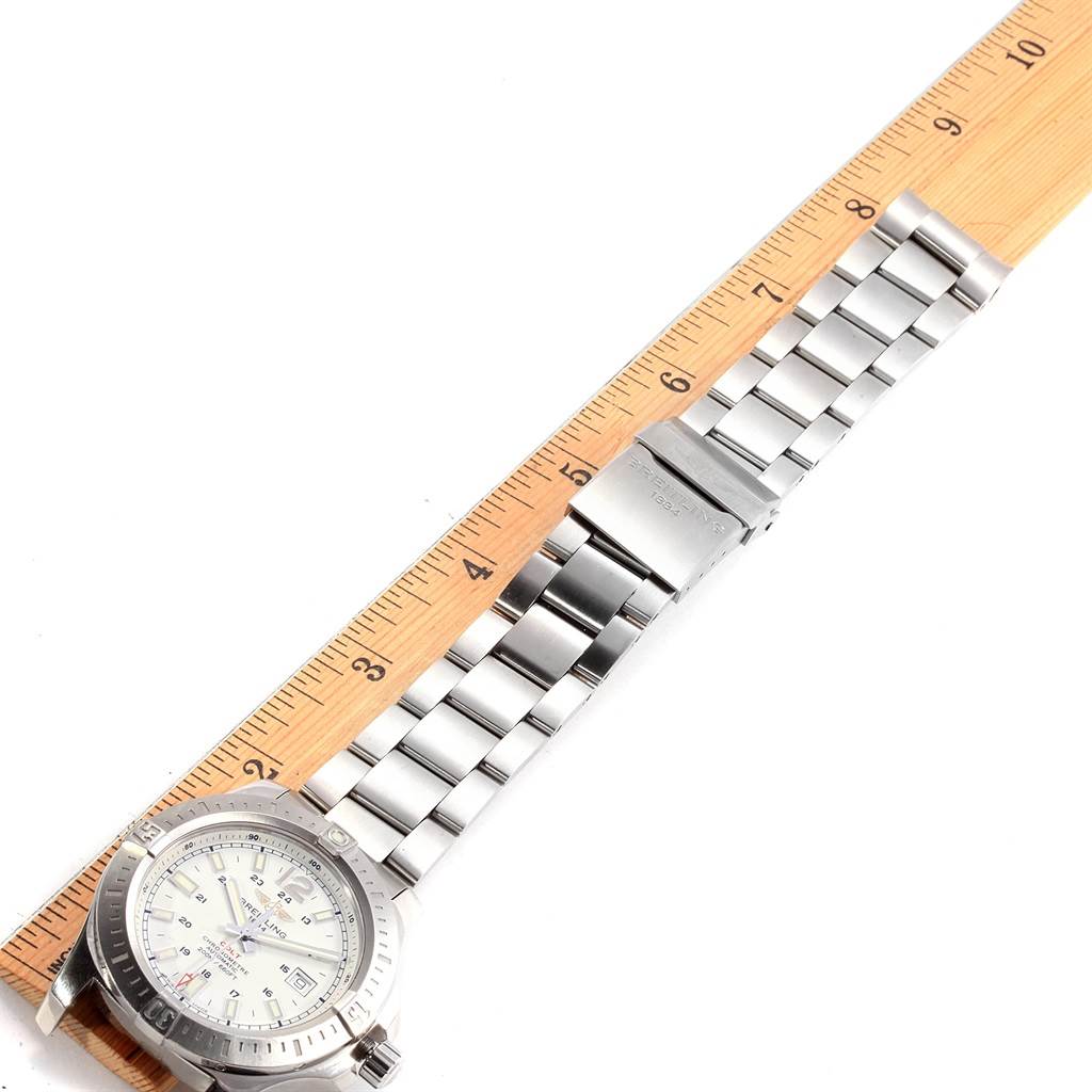 The image shows a Breitling Colt A17388 Men's Stainless Steel White Dial A17388 Men's Stainless Steel White Dial watch face and part of the stainless steel bracelet measured against a wooden ruler.
