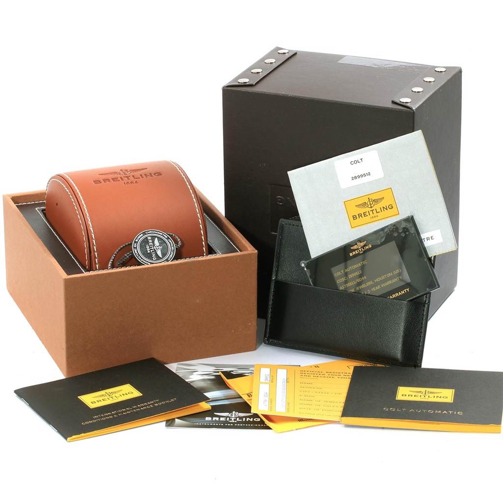 The image shows the packaging and accessories for the Breitling Colt A17388 Men's Stainless Steel Black Dial A17388 Men's Stainless Steel Black Dial model, including the watch box, instruction manuals, and warranty card.