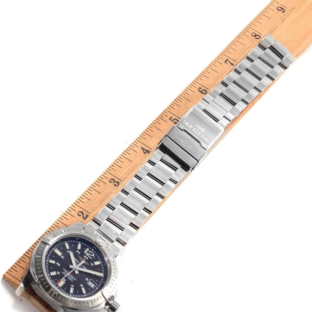 The image shows a Breitling Colt A17313 Men's Stainless Steel Black Dial A17313 Men's Stainless Steel Black Dial watch placed next to a ruler for size reference, displaying the face and stainless steel bracelet.