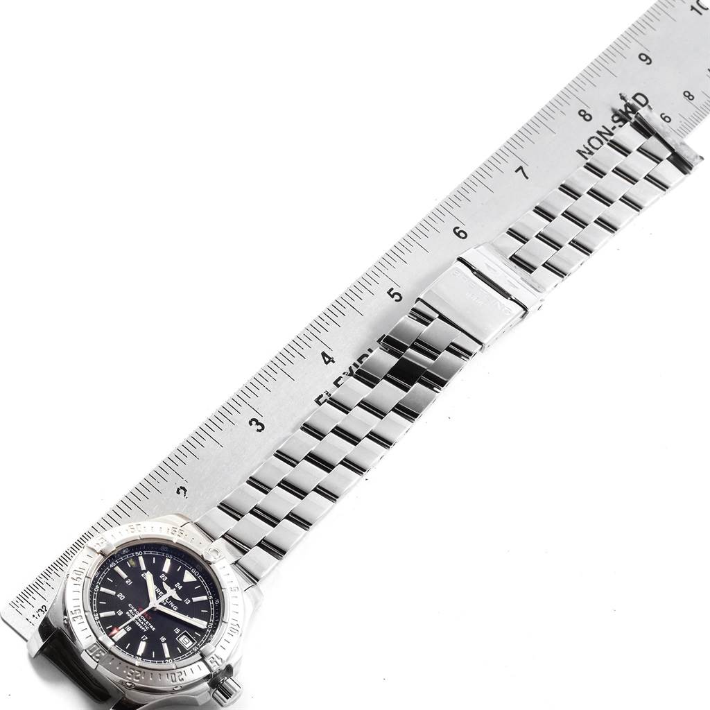 This image shows a top view of a Breitling Colt A17380 Men's Stainless Steel Black Dial A17380 Men's Stainless Steel Black Dial watch with a metal link bracelet next to a ruler.