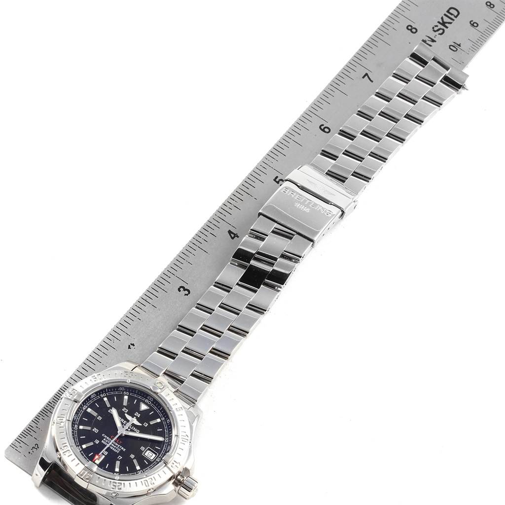 The image shows a Breitling Colt A17380 Men's Stainless Steel Black Dial A17380 Men's Stainless Steel Black Dial watch, laid flat with the face, bezel, bracelet, and clasp visible, positioned alongside a ruler.