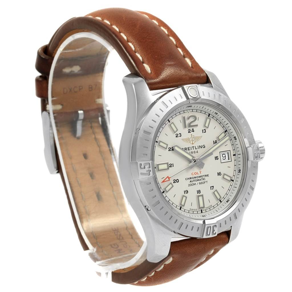 The Breitling Colt A17313 Men's Stainless Steel Silver Dial A17313 Men's Stainless Steel Silver Dial watch is shown at a three-quarter angle, displaying its face, case, and brown leather strap.