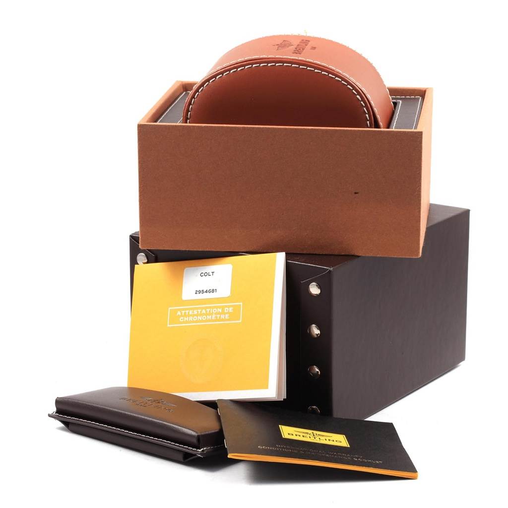 The image shows the packaging and documentation for a Breitling Colt A17313 Men's Stainless Steel Silver Dial A17313 Men's Stainless Steel Silver Dial watch, including the box, leather case, and manuals.