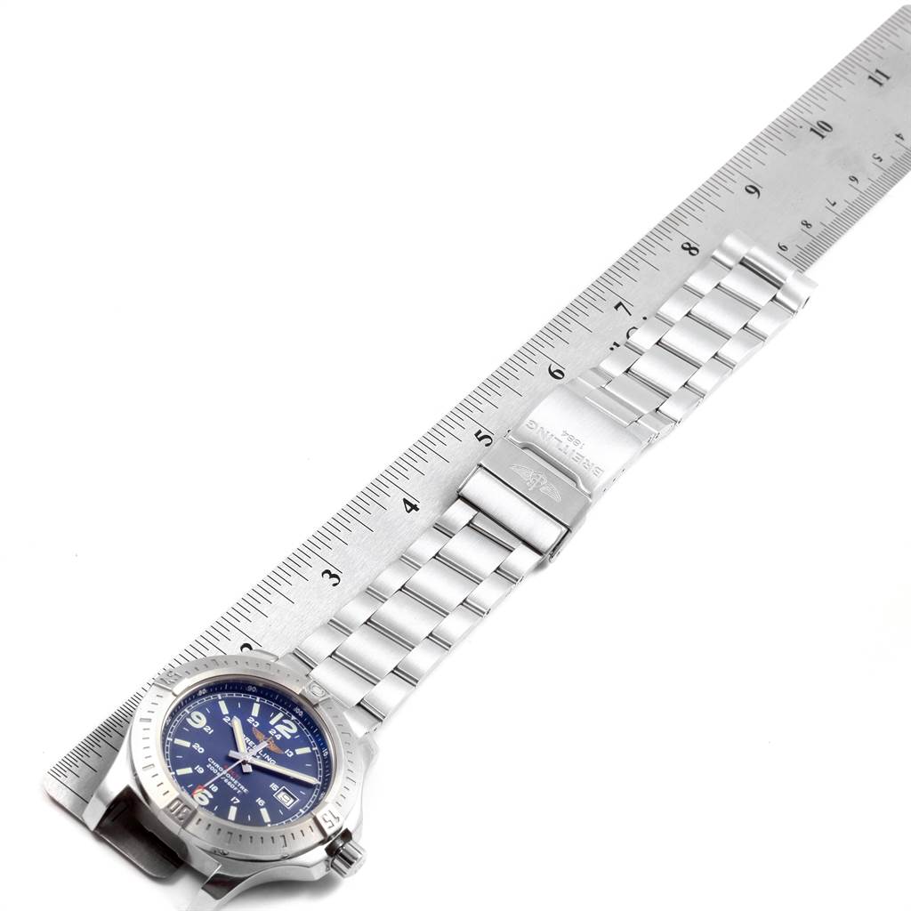 The image shows a Breitling Colt A74388 Men's Stainless Steel Blue Dial A74388 Men's Stainless Steel Blue Dial watch placed on a ruler, displaying the full watch face and the length of the metal bracelet.