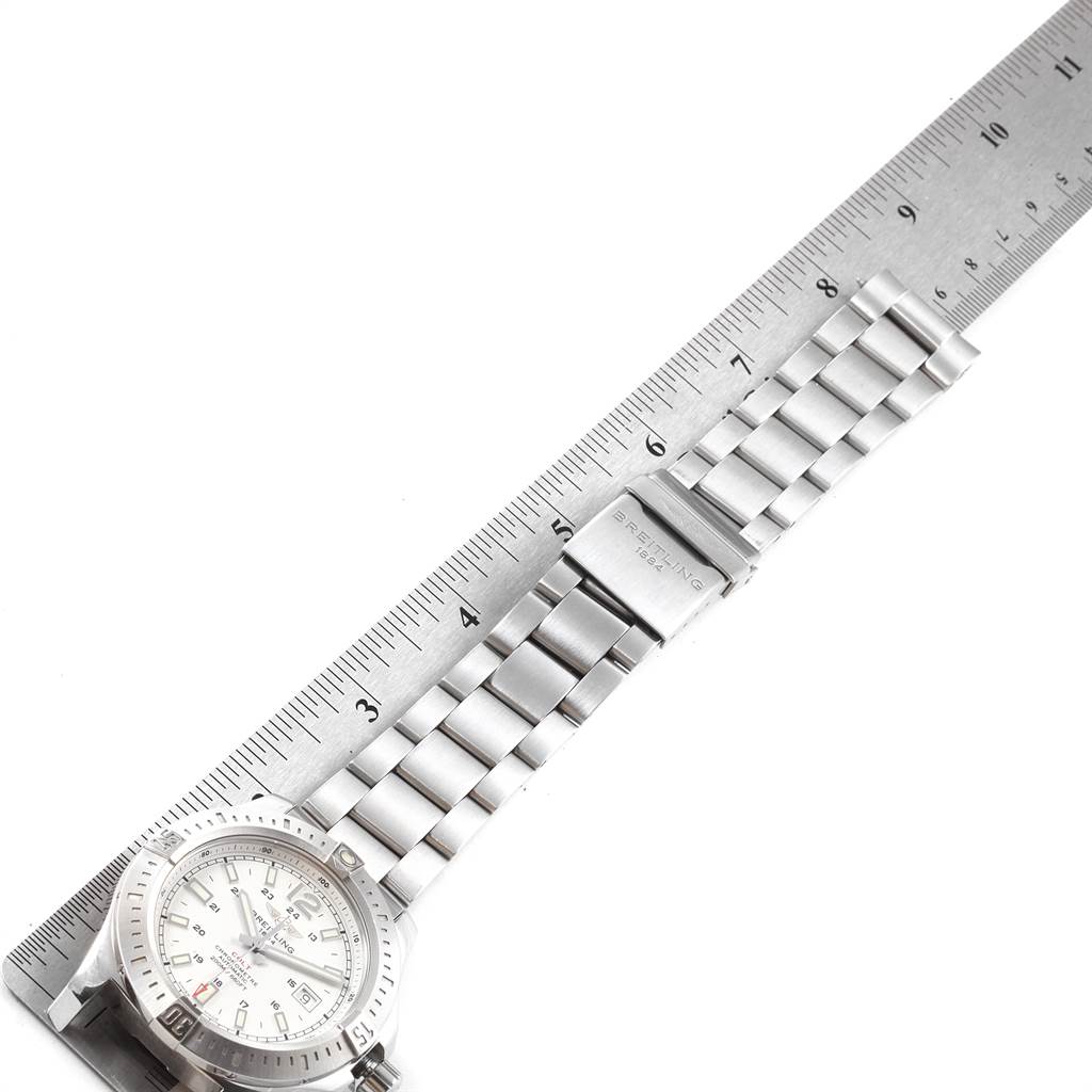 The image shows the Breitling Colt A17388 Men's Stainless Steel White Dial A17388 Men's Stainless Steel White Dial watch diagonally with its band extended and measured by a ruler.