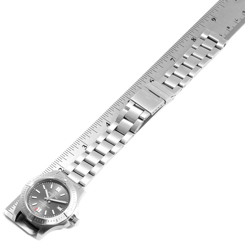The image shows a Breitling Colt A17313 Men's Stainless Steel Grey Dial A17313 Men's Stainless Steel Grey Dial watch laid along a ruler, displaying its face, bracelet, and clasp.