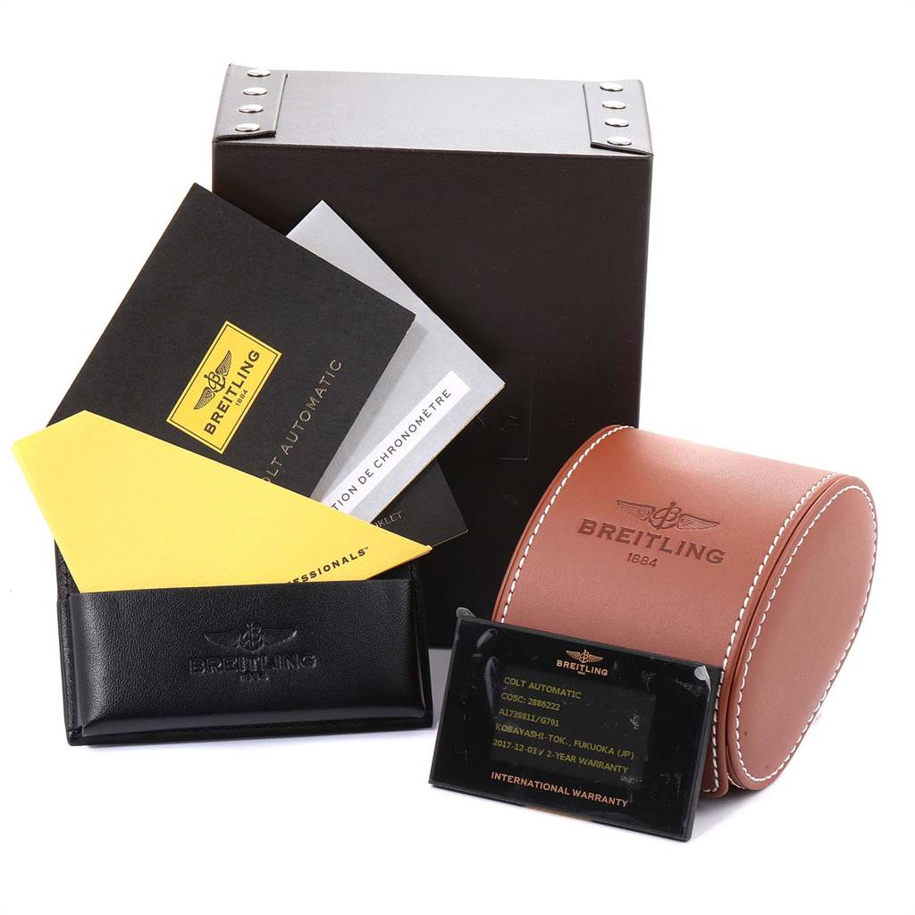The Breitling Colt A17388 Men's Stainless Steel White Dial A17388 Men's Stainless Steel White Dial model watch accessories are displayed, including the box, warranty card, manuals, and a leather travel case.