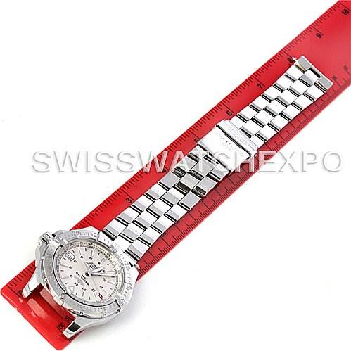 The image shows a top-down view of a Breitling Colt A17380 Men's Stainless Steel Silver Dial A17380 Men's Stainless Steel Silver Dial watch, including its face and metal bracelet, placed next to a red ruler.