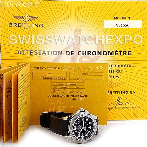 The image shows a Breitling Colt A32350 Men's Stainless Steel Grey Dial A32350 Men's Stainless Steel Grey Dial watch positioned front-facing, along with its warranty certificate and chronometer attestation papers.