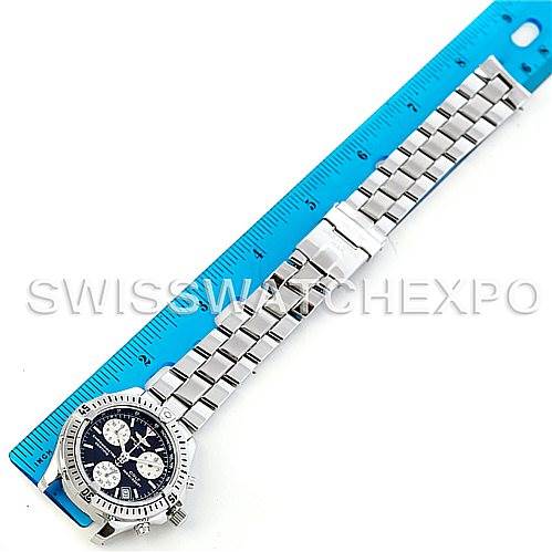 The image shows an overhead view of a Breitling Colt A53035 Men's Stainless Steel Black Dial A53035 Men's Stainless Steel Black Dial watch, with a blue ruler next to its steel bracelet for scale.