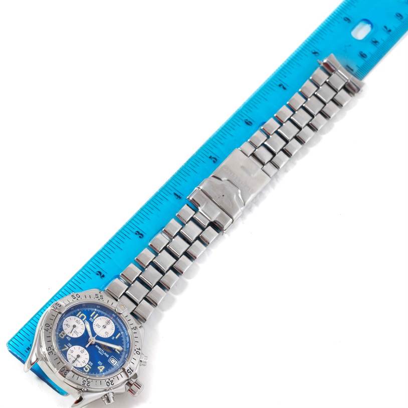 The image shows a Breitling Colt A13035 Men's Stainless Steel Blue Dial A13035 Men's Stainless Steel Blue Dial watch laid flat beside a ruler, displaying the entire bracelet and face.
