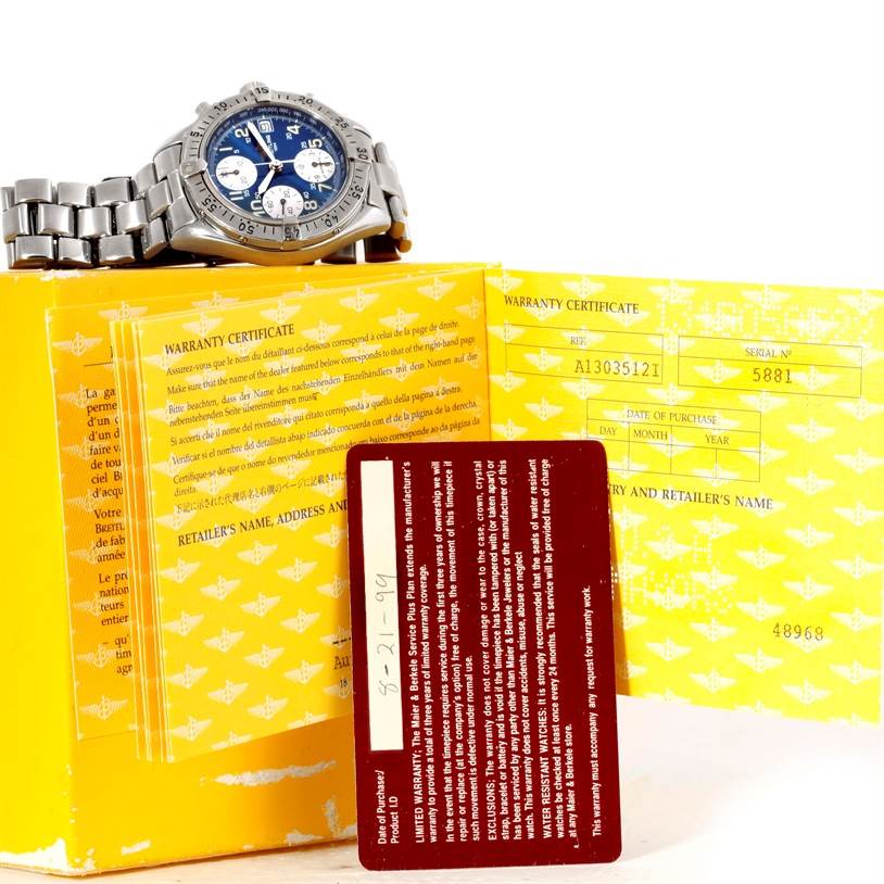 The Breitling Colt A13035 Men's Stainless Steel Blue Dial A13035 Men's Stainless Steel Blue Dial watch is shown from a slight side angle, along with its warranty certificate and a red warranty card.