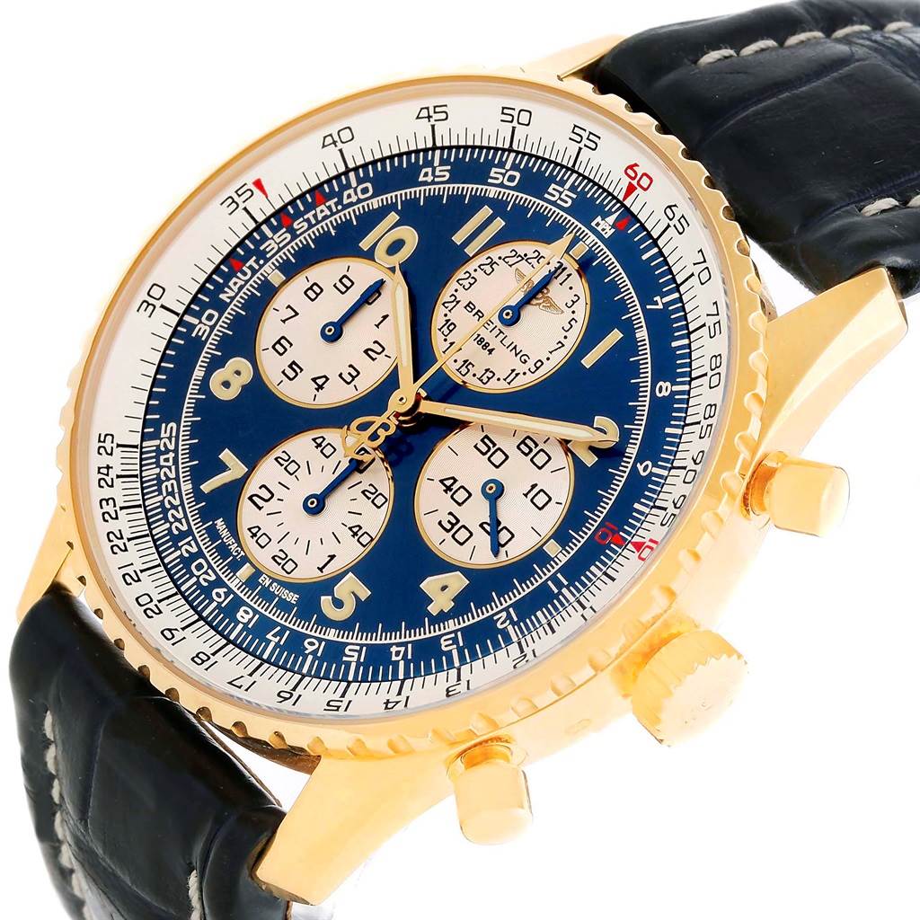The image shows a Breitling Navitimer K33030 Men
s Yellow Gold Blue Dial K33030 Men
s Yellow Gold Blue Dial watch at an angled close-up, highlighting its gold casing, blue dial with subdials, and black leather strap.