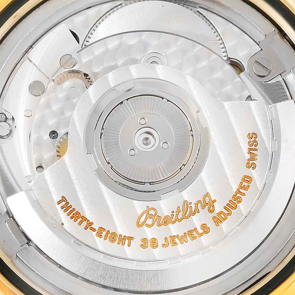 This close-up shot of a Breitling Navitimer K33030 Men
s Yellow Gold Blue Dial K33030 Men
s Yellow Gold Blue Dial watch shows its automatic movement with "Thirty-Eight 38 Jewels Adjusted Swiss" text.
