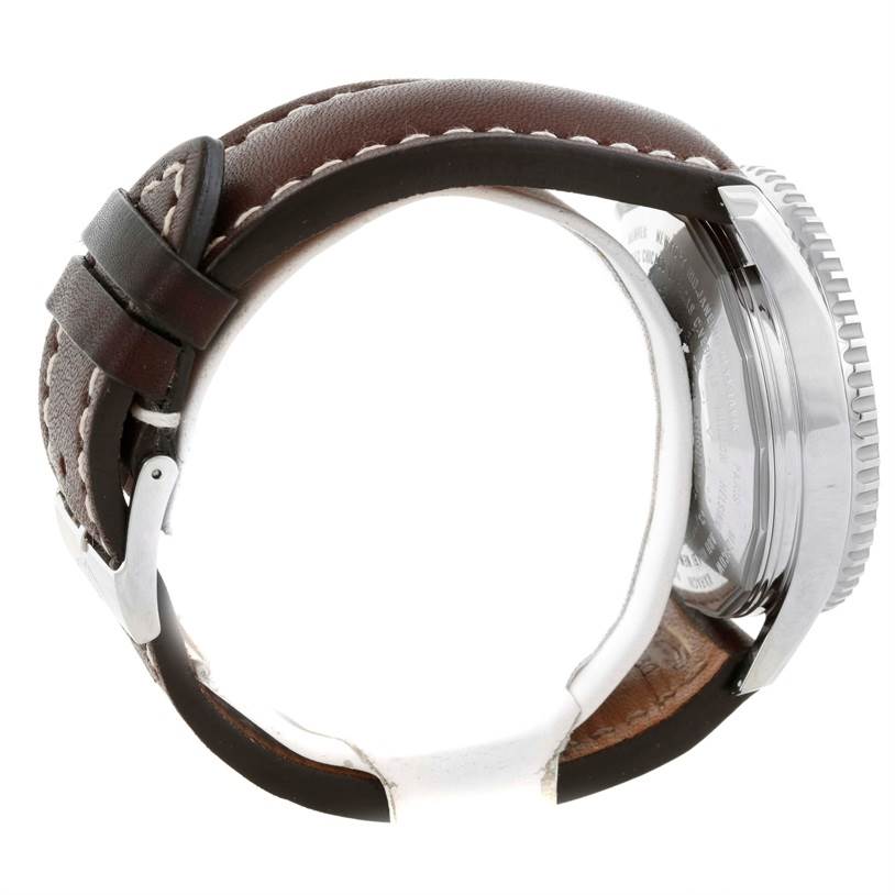 This image shows a Breitling Navitimer A24322 Men's Stainless Steel Silver Dial A24322 Men's Stainless Steel Silver Dial watch from the side, highlighting its brown leather strap and the metal case back.