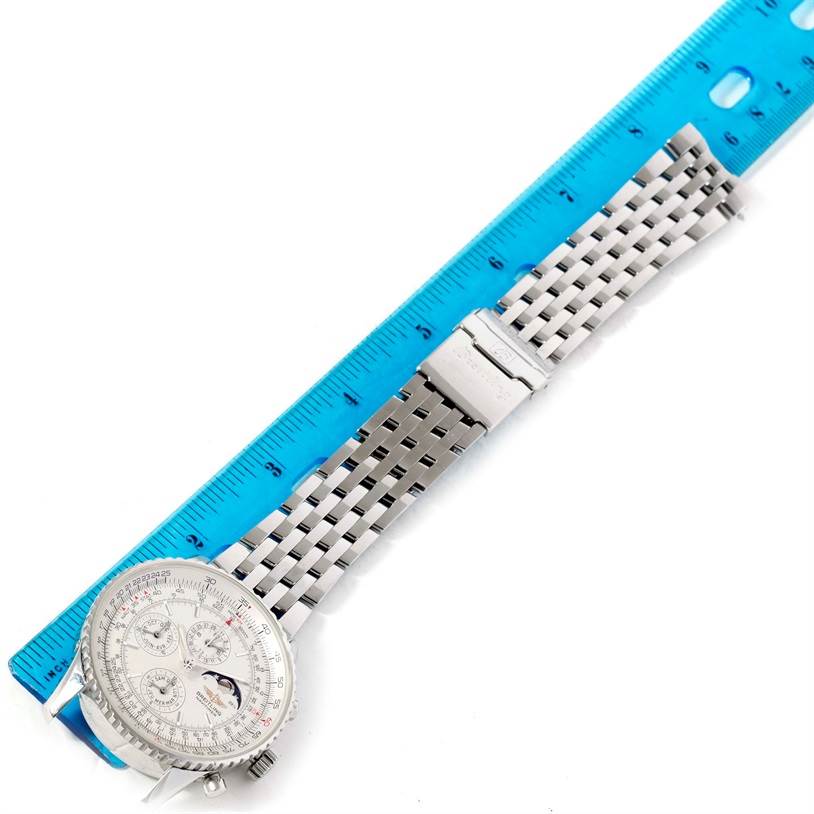 The image shows a Breitling Navitimer A19340 Men's Stainless Steel Silver Dial A19340 Men's Stainless Steel Silver Dial watch with a metal bracelet, lying flat next to a blue ruler for scale.