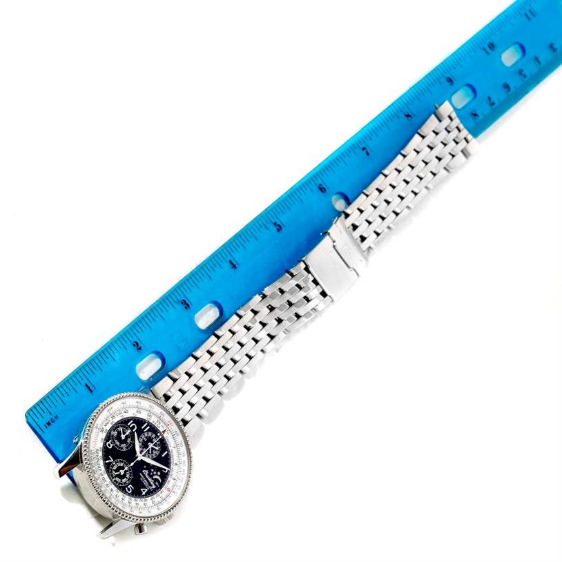 The image shows a Breitling Navitimer A19350 Men's Stainless Steel Silver Dial A19350 Men's Stainless Steel Silver Dial watch laid flat with a blue ruler measuring its metal bracelet.