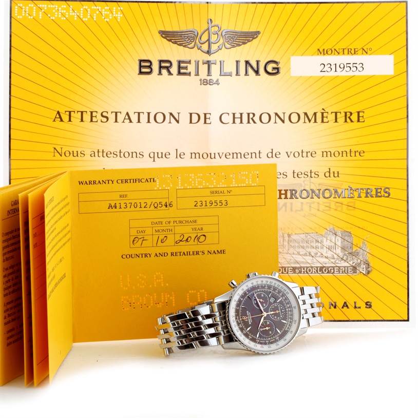 The Breitling Navitimer A41370 Men
s Stainless Steel Brown Dial A41370 Men
s Stainless Steel Brown Dial watch is shown at an angle, accompanied by its warranty certificate and attestation of chronometer.