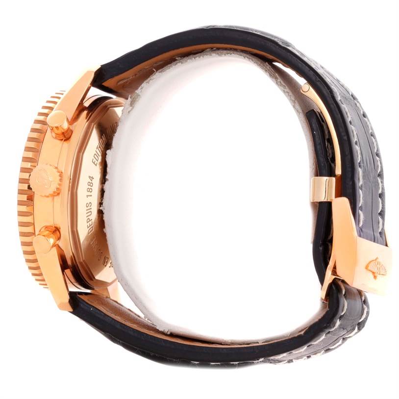 The image shows a side view of a Breitling Navitimer R26322 Men's Rose Gold Black Dial R26322 Men's Rose Gold Black Dial watch, highlighting the case, crown, pushers, and a portion of the strap.