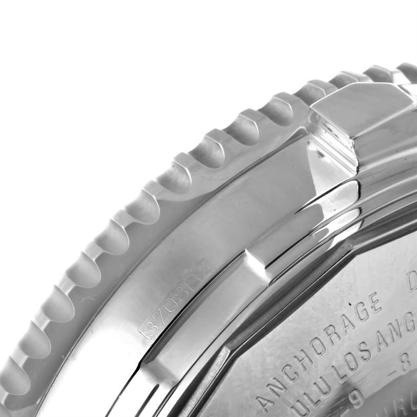 The image shows a close-up of the bezel and case back of a Breitling Navitimer A24322 Men's Stainless Steel Silver Dial A24322 Men's Stainless Steel Silver Dial watch.