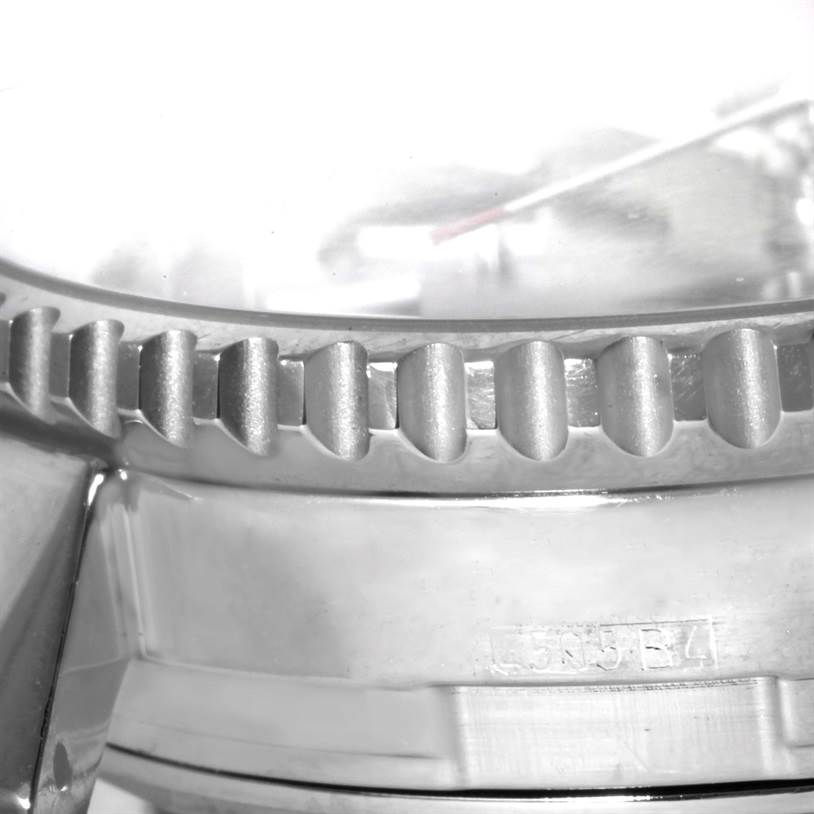 This close-up image of a Breitling Navitimer A24322 Men's Stainless Steel Black Dial A24322 Men's Stainless Steel Black Dial watch shows the textured bezel and a small part of the case.