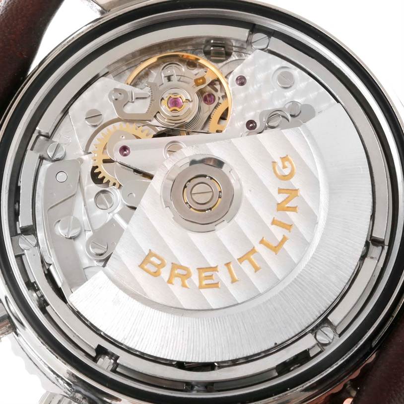 The image shows the back of a Breitling Navitimer A23322 Men's Stainless Steel Silver Dial A23322 Men's Stainless Steel Silver Dial watch, highlighting its automatic movement mechanism with visible gears.