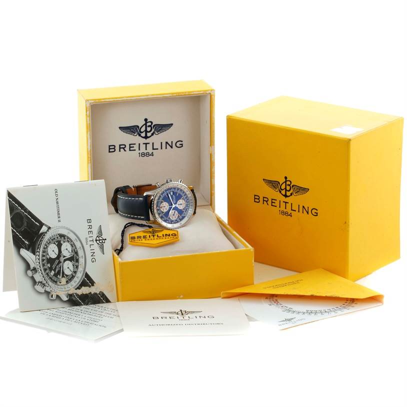 The image shows a Breitling Navitimer A13022 Men's Stainless Steel Blue Dial A13022 Men's Stainless Steel Blue Dial watch at an angle with its box, manuals, tag, and additional paperwork.